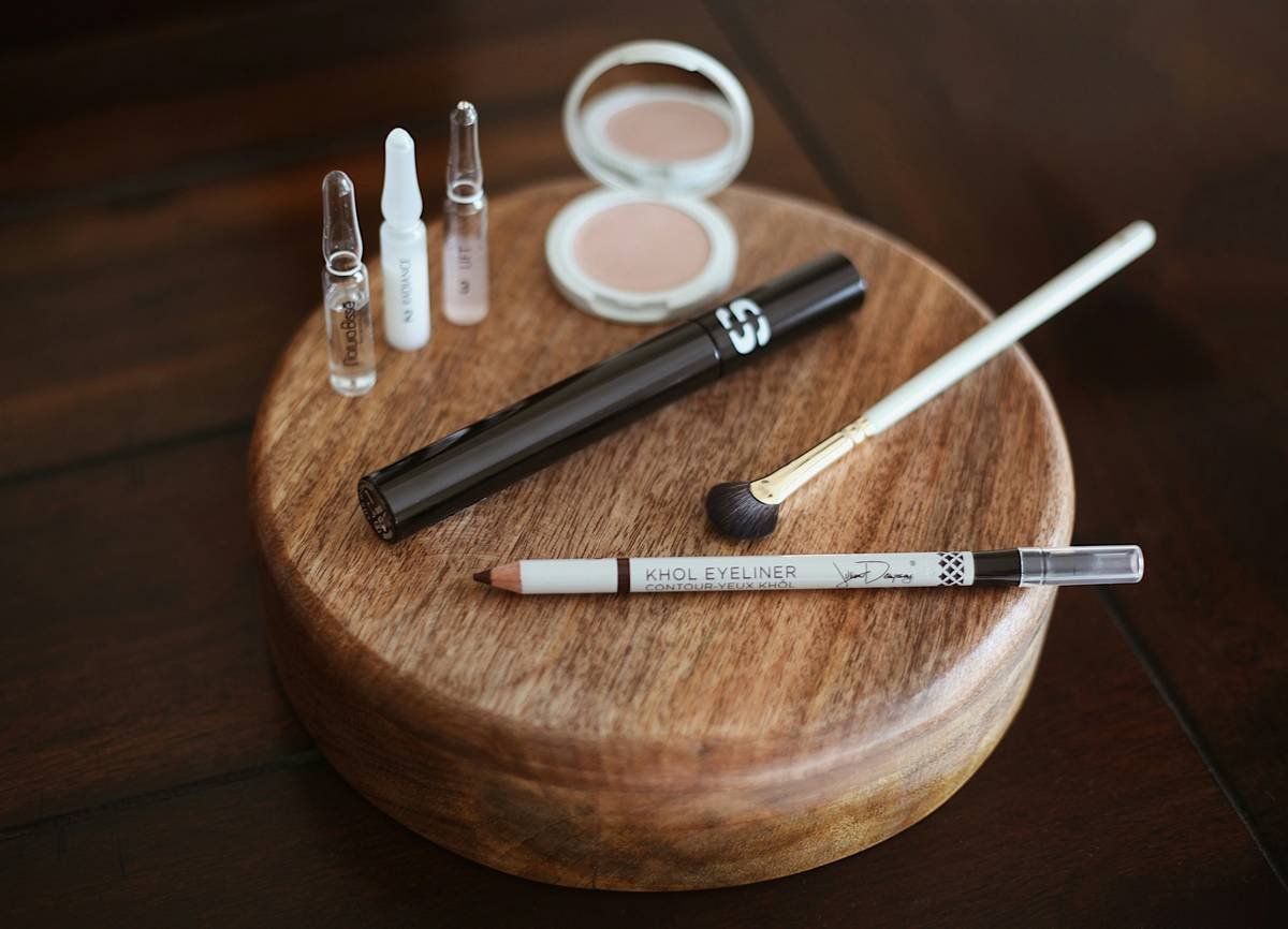 Infographic showing 3 essential components of a professional brow styling kit: clear tinted gel, dual-ended angled brush/spoolie, and microfiber applicator