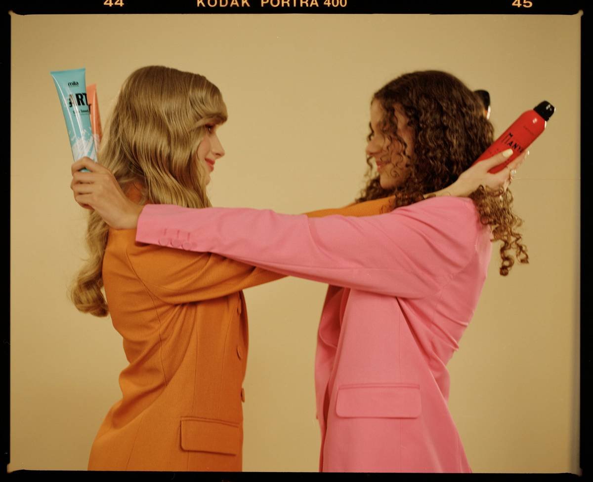 Woman applying clear eyebrow product with precision spoolie brush