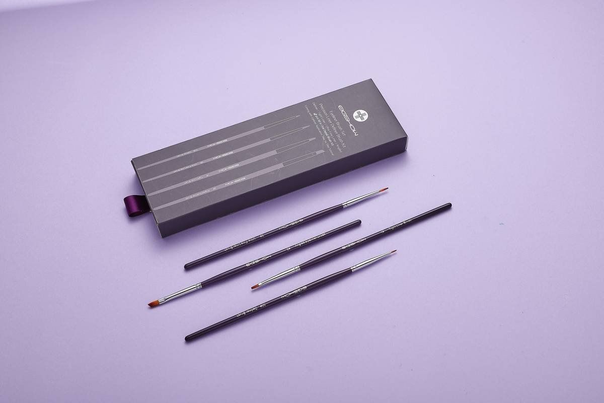 eyebrow defining kit with angled brush, tinted gel, and micro-spoolie on marble surface