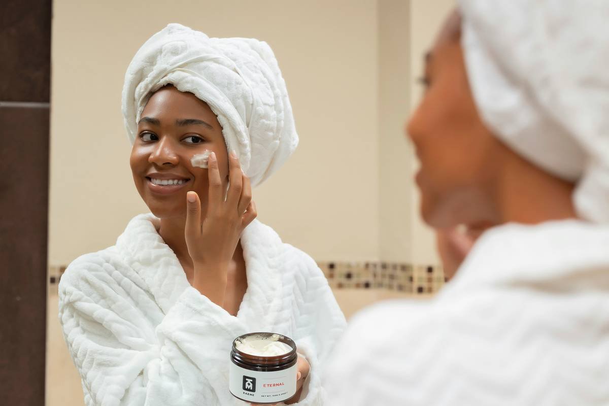 Woman applying clear brow hold gel with spoolie brush for natural-looking eyebrows